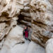 girl going through the slot canyon