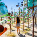 girl posing away from camera in the middle of the bottle trees